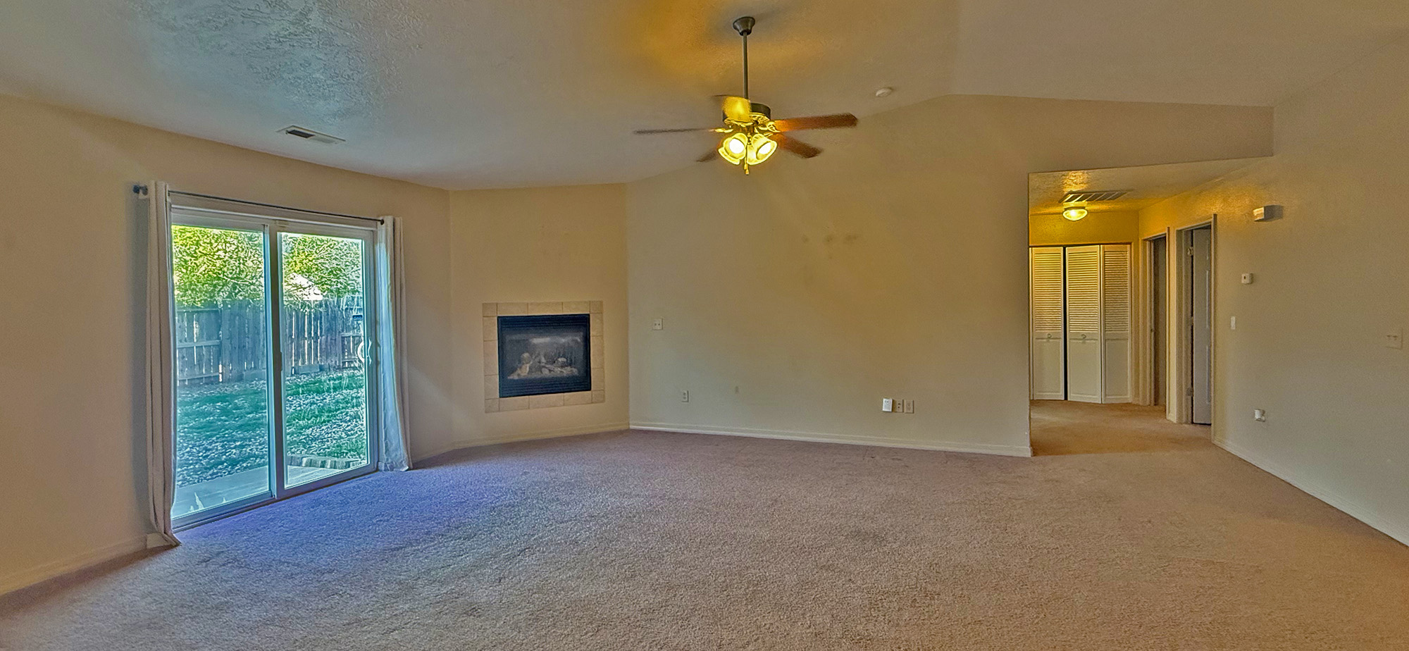 Great Room with patio door, fireplace, and hallway